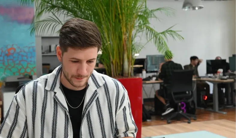 A Tessan team member focused at work in the open-plan Paris office.